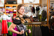 Woman is trying Tracht or dirndl in a shop
