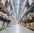 Photo: Modern warehouse with cardboard boxes and rows of shelves Modern warehouse with cardboard boxes and rows of shelves
