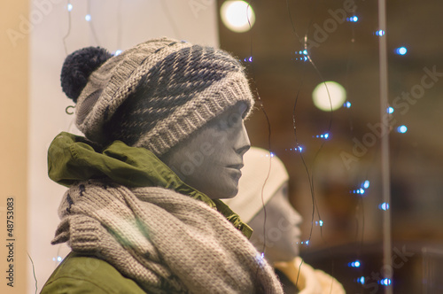 Photo: Mannequins in winter jackets and hats with scarfs and light bulb Mannequins in winter jackets and hats with scarfs and light bulb
