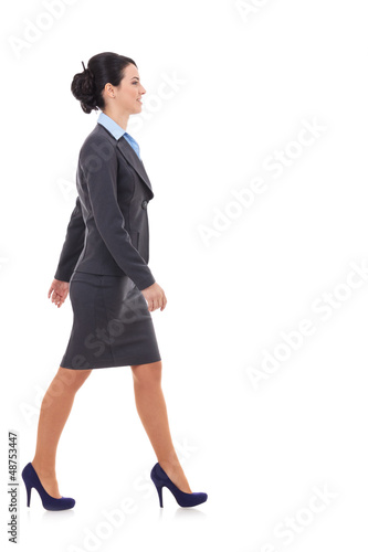 Photo: Side view of a business woman walking Side view of a business woman walking