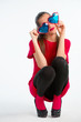 Young woman in red with heart shaped glasses
