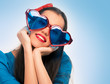 Portrait of a beautiful woman in blue with heart shaped glasses