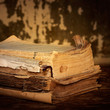 Dilapidated books on a wooden surface, sepia