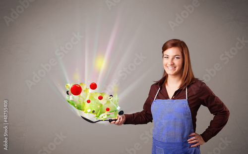Photo: Young woman cooking fresh vegetables Young woman cooking fresh vegetables