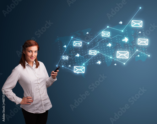 Photo: Young lady holding a phone with arrows and message icons Young lady holding a phone with arrows and message icons