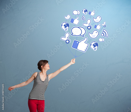 Photo: Pretty woman holding social icon balloon Pretty woman holding social icon balloon