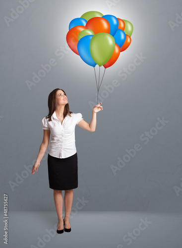 Photo: Young woman holding colorful balloons Young woman holding colorful balloons
