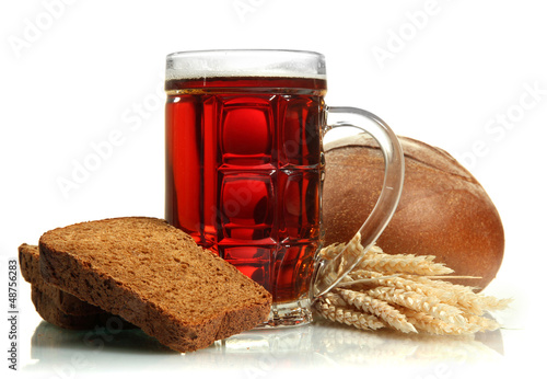 Photo: tankard of kvass and rye breads with ears, isolated on white tankard of kvass and rye breads with ears, isolated on white