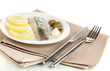 Dish of herring and lemon on plate isolated on white