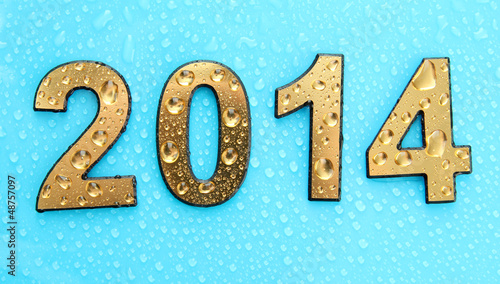 Photo: 2014 in golden numbers, on blue background 2014 in golden numbers, on blue background