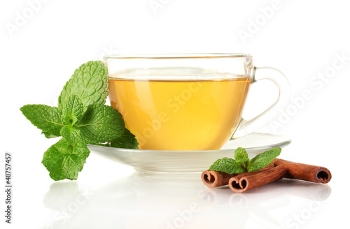 Photo: Cup of tea with mint and cinnamon isolated on white Cup of tea with mint and cinnamon isolated on white