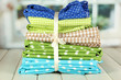 Color mottled fabrics on wooden table on window background
