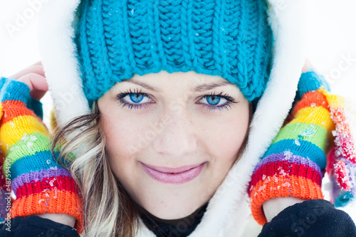 Photo: Closeup Portrait of Attractive young woman in wintertime outdoor Closeup Portrait of Attractive young woman in wintertime outdoor