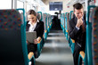 Business on the move. Business people using computers on the tra