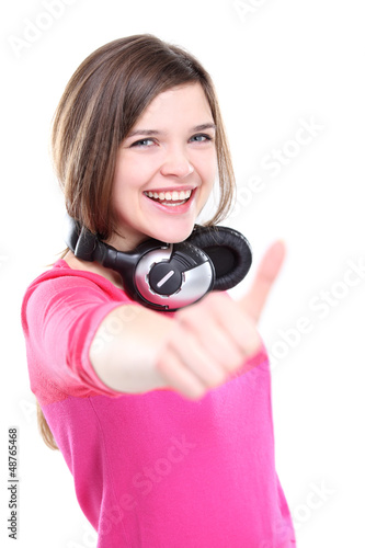 Photo: Closeup of a happy young girl with thumb's up sign Closeup of a happy young girl with thumb's up sign