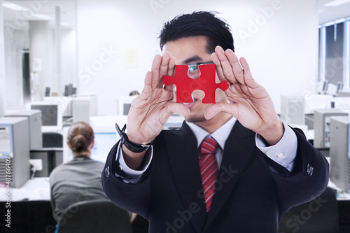 Photo: Businessman shows missing piece Businessman shows missing piece