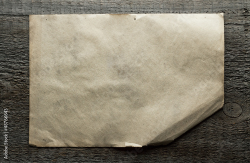 Photo: old paper on wooden background old paper on wooden background