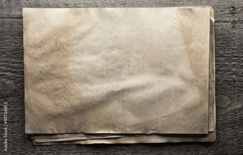 Photo: old papers on wooden background old papers on wooden background