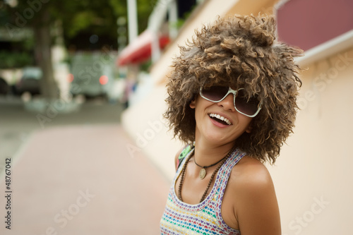 Photo: A beautiful young woman in a wig of curly hair A beautiful young woman in a wig of curly hair
