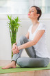 Photo: Portrait of a young beauty sitting and relaxing at home or fitne Portrait of a young beauty sitting and relaxing at home or fitne