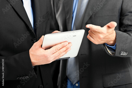 Photo: Businessmen watching a tablet Businessmen watching a tablet