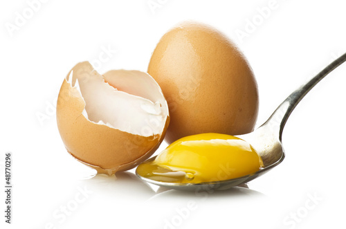 Photo: Broken egg close up on the spoon Broken egg close up on the spoon