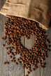 Heart shape made from coffee beans on wooden table