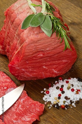 Photo: Raw beef on wooden table Raw beef on wooden table