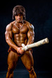 Portrait of a muscular man with a wooden club