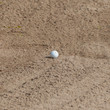 A golf ball in a sand trap
