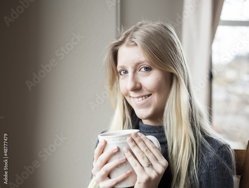 Photo: Young Woman Drinking Coffee Young Woman Drinking Coffee
