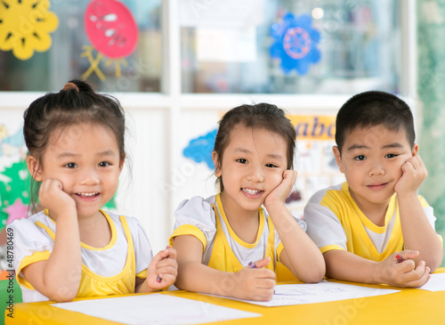 Photo: Boy and girls sitting in the kindergarten Boy and girls sitting in the kindergarten