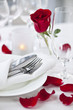 Photo: Romantic dinner setting with rose petals Romantic dinner setting with rose petals
