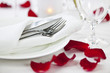 Photo: Romantic dinner setting with rose petals Romantic dinner setting with rose petals
