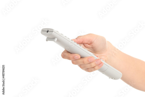 Photo: Beautiful woman hand with a tv remote control Beautiful woman hand with a tv remote control