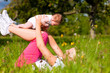 Mother playing with baby on meadow