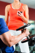 Personal Trainer in gym and dumbbell training
