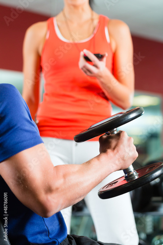 Photo: Personal Trainer in gym and dumbbell training Personal Trainer in gym and dumbbell training