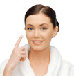 woman in bathrobe applying creme