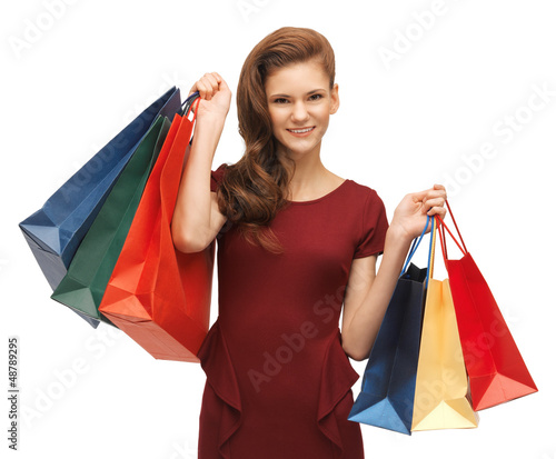 Photo: teenage girl in red dress with shopping bags teenage girl in red dress with shopping bags