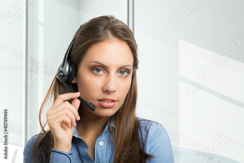 Photo: Woman using an headset Woman using an headset