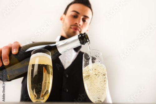 Photo: Waiter pouring champagne Waiter pouring champagne