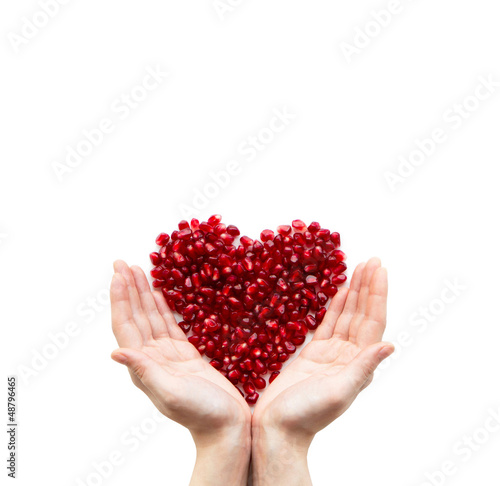 Photo: Pomegranate heart in hands Pomegranate heart in hands