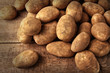 Fresh potatoes on wooden background