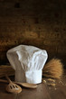 Chef hat and spoons with brick background