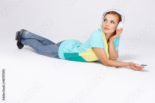 Photo: Young woman listening to music Young woman listening to music