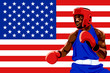 Amateur boxer in protective uniform posing over USA flag