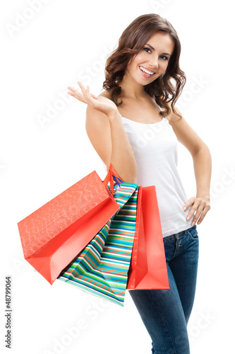 Photo: Young happy woman with shopping bags, isolated Young happy woman with shopping bags, isolated
