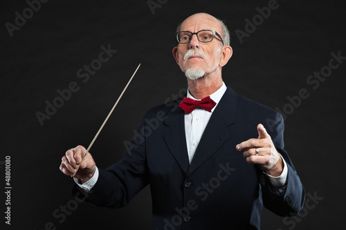 Photo: Senior conductor wearing suit. Studio shot. Senior conductor wearing suit. Studio shot.