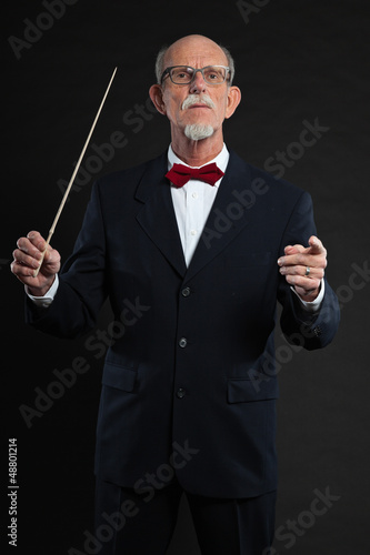 Photo: Senior conductor wearing suit. Studio shot. Senior conductor wearing suit. Studio shot.
